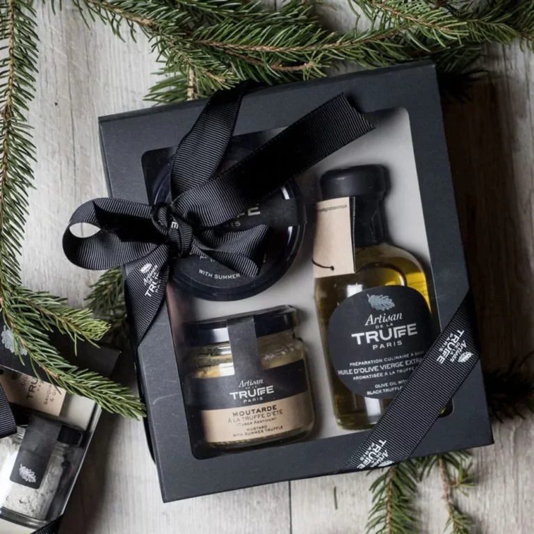 Coffret gourmand Artisan de la Truffe Paris comprenant huile d’olive à la truffe, moutarde à la truffe et spécialités gastronomiques, présenté dans un écrin noir élégant.